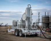 Trailer-mounted mobile H2S scrubber skid connected to temporary piping at a Western Canadian oil and gas lease during temporary sour gas treating
